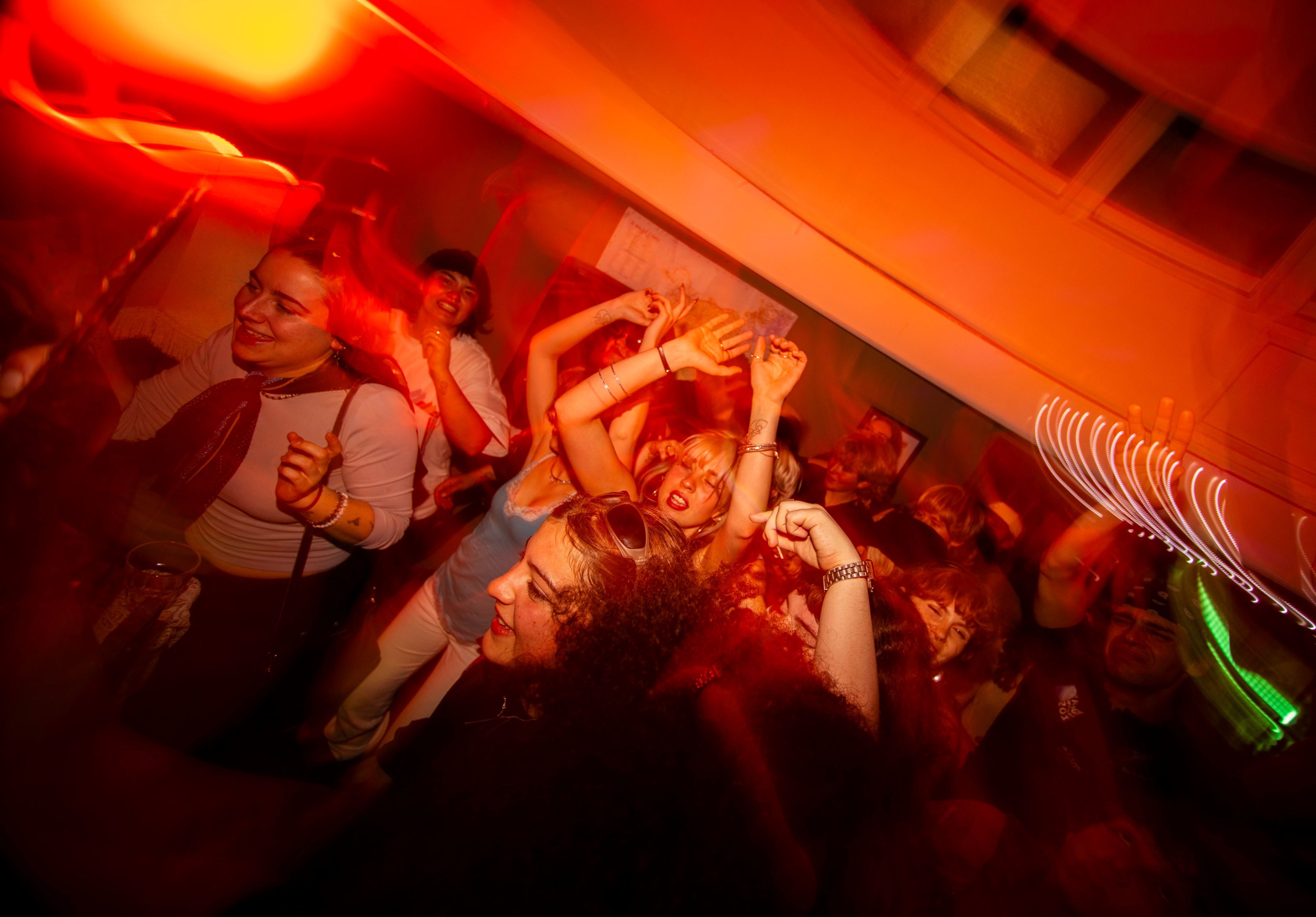 A dancefloor, with warm lighting and smiling faces