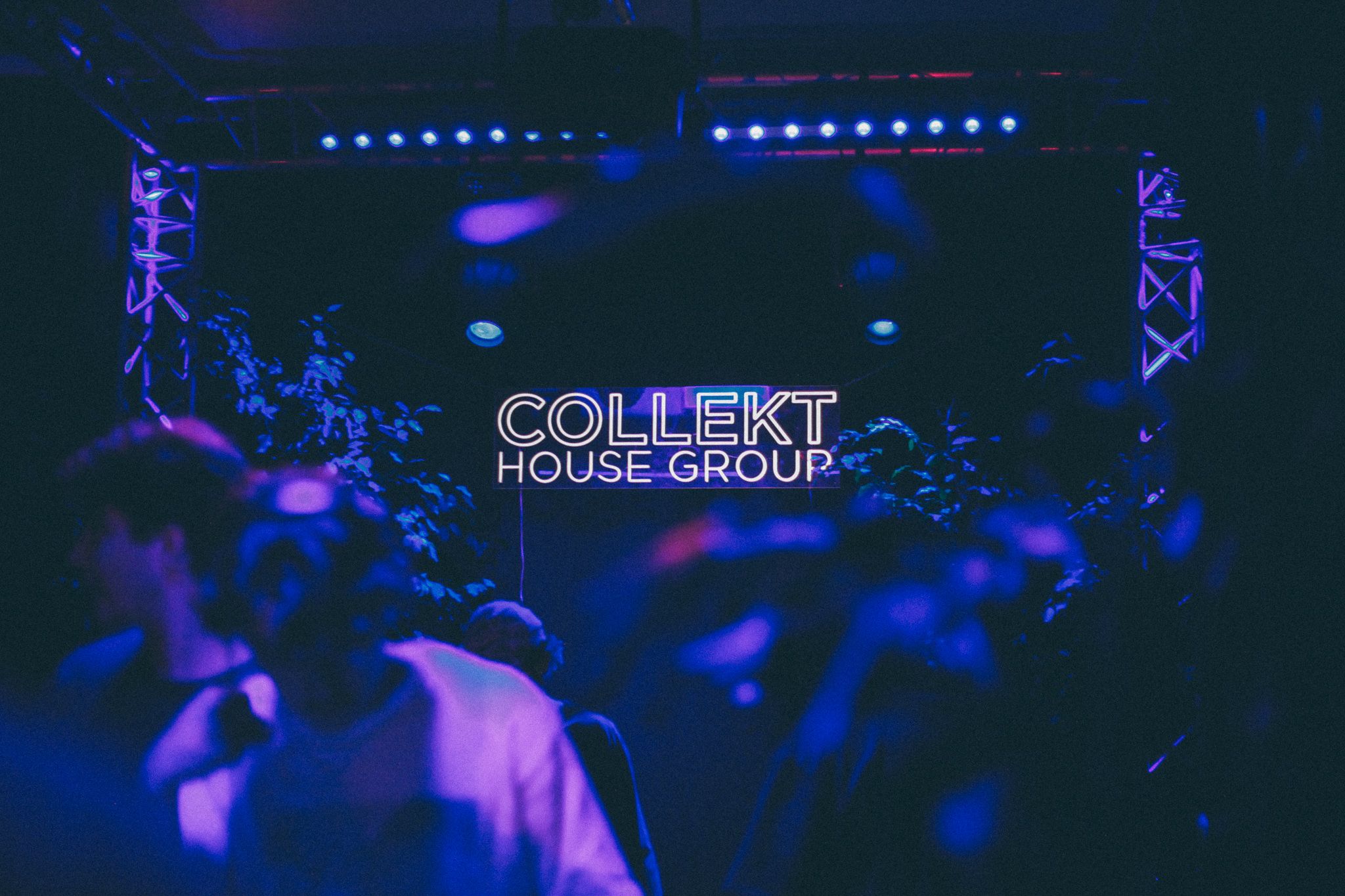A purple-lit image of a dancefloor with the 'collekt' logo lit up