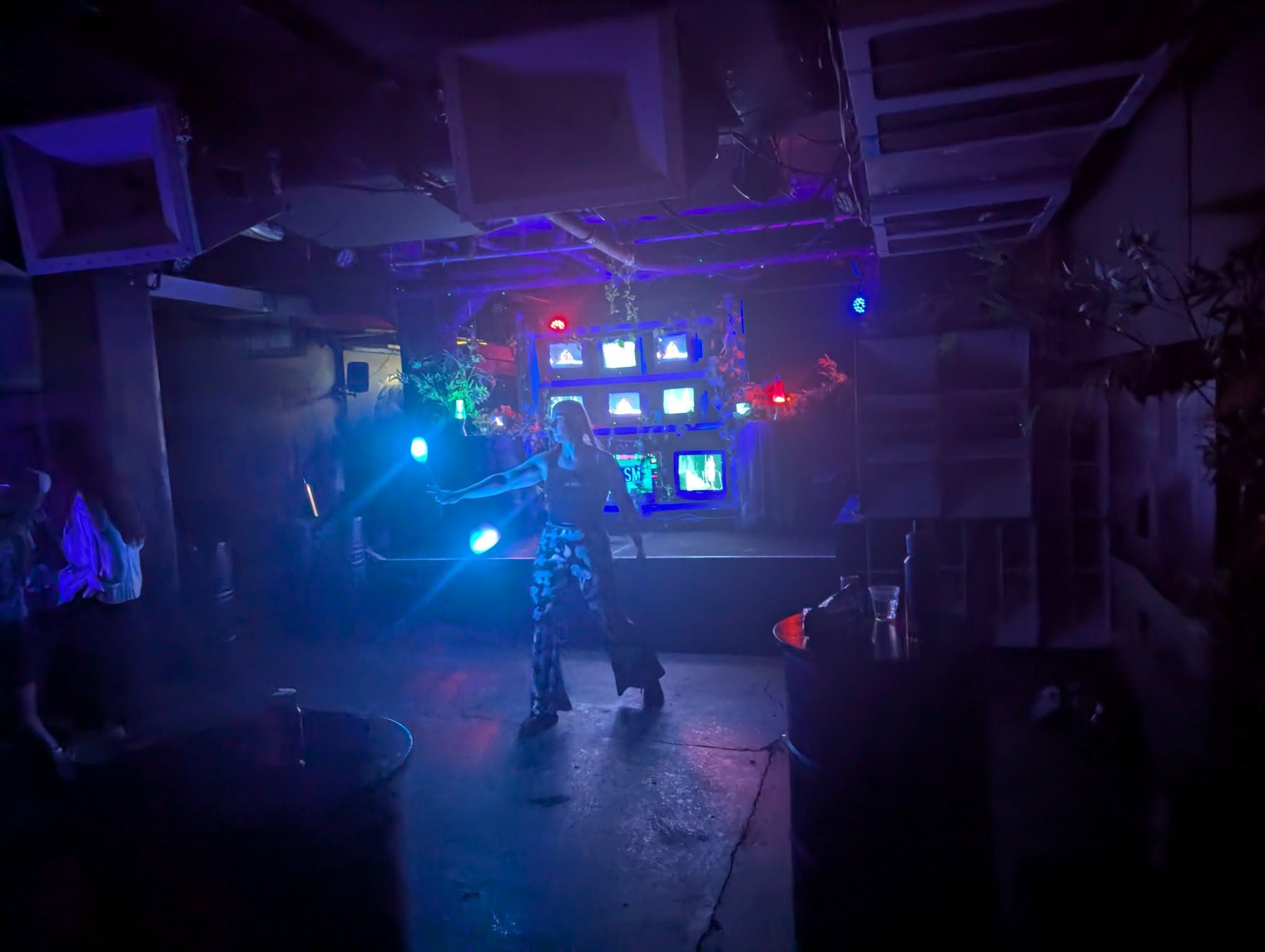 someone spinning glowpoi inside a venue