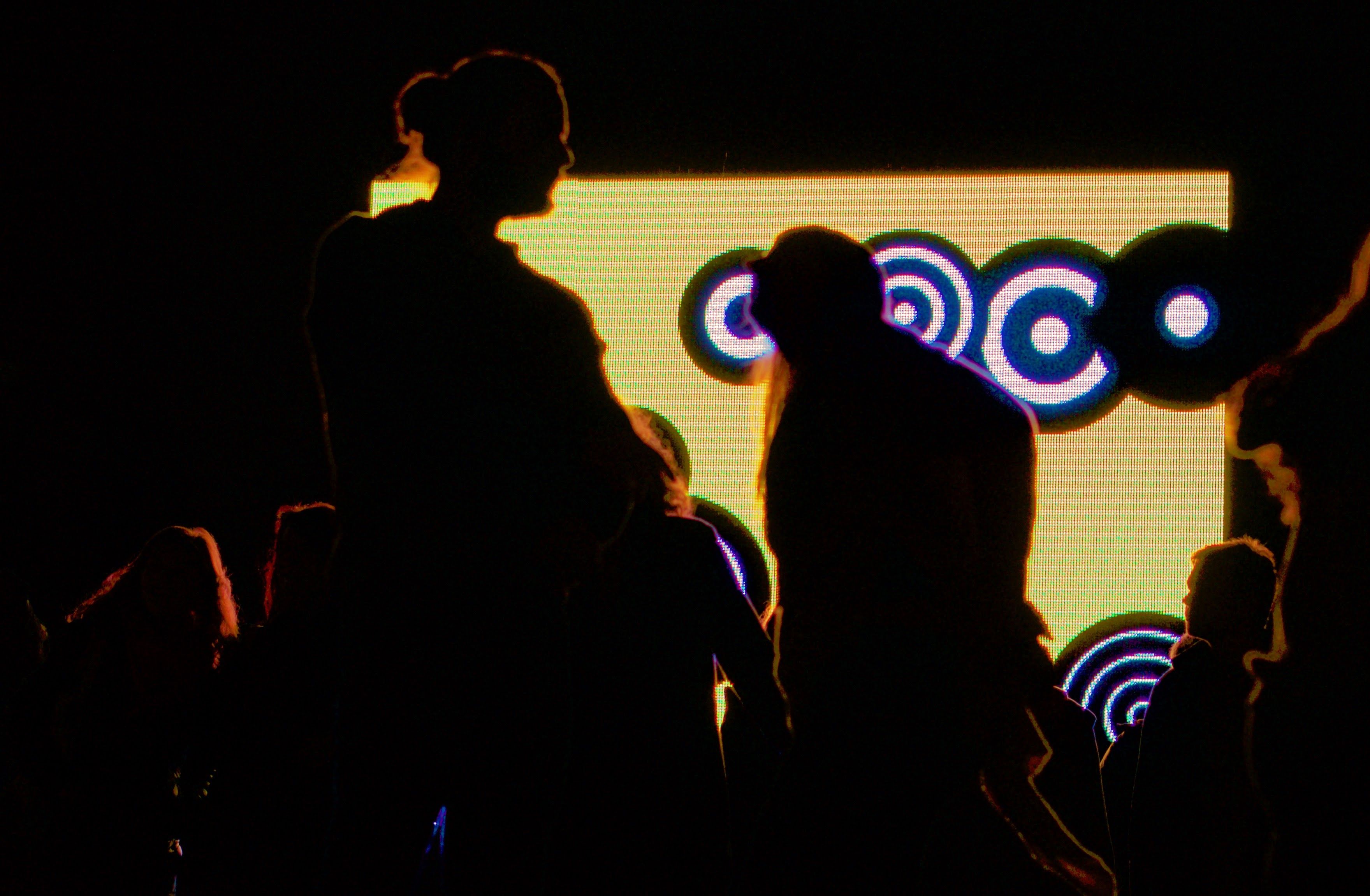 silhouettes in front of a screen